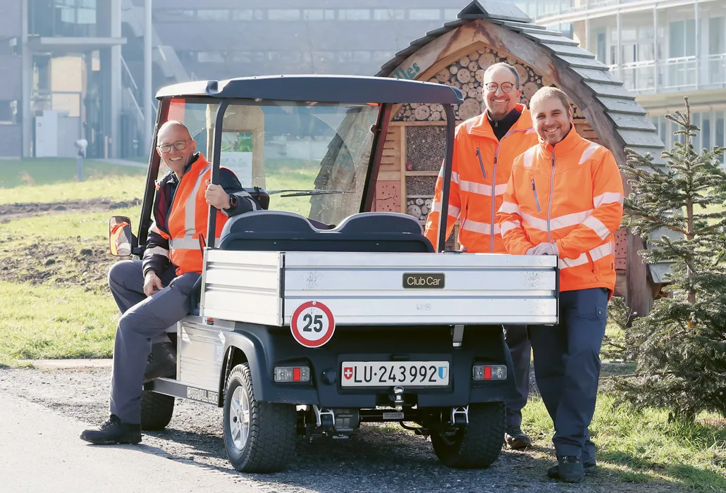 Die Unterhaltsmitarbeitenden mit dem Club Car vor dem SPZ